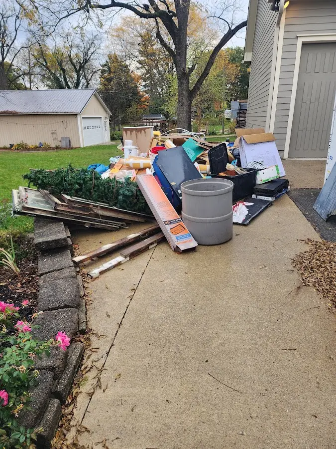 Dumpster being loaded with debris for Roofing Dumpster Rental in Aurora